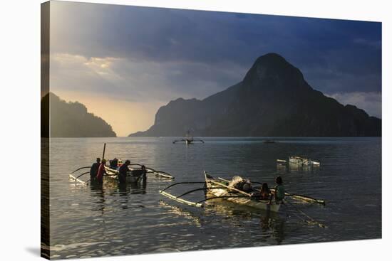 Outrigger Boat at Sunset in the Bay of El Nido, Bacuit Archipelago, Palawan, Philippines-Michael Runkel-Stretched Canvas