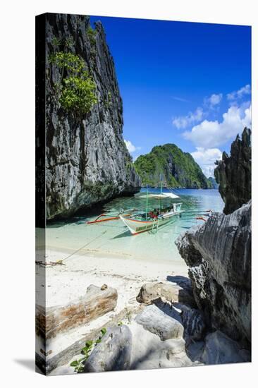 Outrigger Boat on a Little White Beach and Crystal Clear Water in the Bacuit Archipelago-Michael Runkel-Stretched Canvas