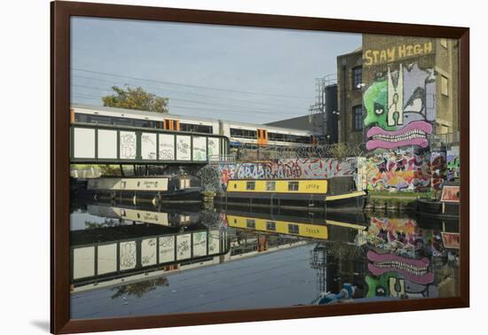 Overground train drives past canal by artists studios and warehouses in Hackney Wick, London, Engla-Julio Etchart-Framed Photographic Print