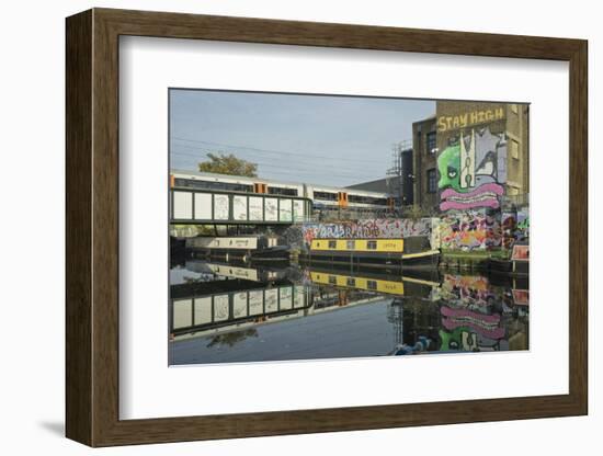 Overground train drives past canal by artists studios and warehouses in Hackney Wick, London, Engla-Julio Etchart-Framed Photographic Print