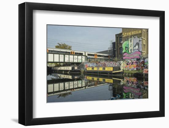 Overground train drives past canal by artists studios and warehouses in Hackney Wick, London, Engla-Julio Etchart-Framed Photographic Print