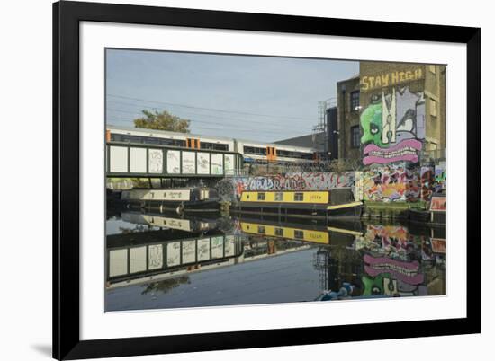 Overground train drives past canal by artists studios and warehouses in Hackney Wick, London, Engla-Julio Etchart-Framed Photographic Print