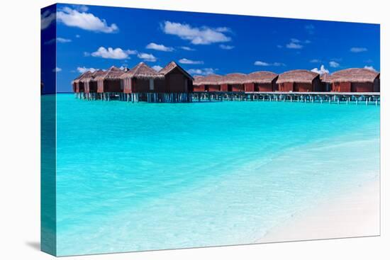 Overwater Villas in Blue Tropical Lagoon with White Sandy Beach-Martin Valigursky-Stretched Canvas