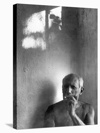 Pablo Picasso, Bare Chested and Smoking Cigarette-Gjon Mili-Stretched Canvas