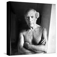Pablo Picasso, Bare Chested and with Flower Tucked Behind Ear-Gjon Mili-Stretched Canvas