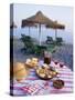 Paella with Olives, Bread and Sangria on a Table on the Beach in Andalucia, Spain-Michael Busselle-Stretched Canvas