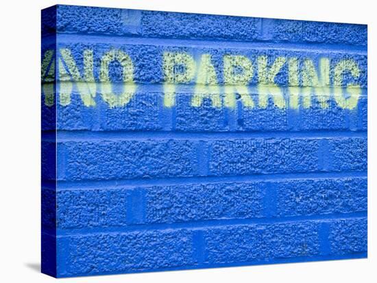 Painted Blue Brick Wall with No Parking Sign-John Nordell-Stretched Canvas
