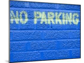 Painted Blue Brick Wall with No Parking Sign-John Nordell-Mounted Photographic Print