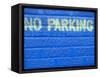 Painted Blue Brick Wall with No Parking Sign-John Nordell-Framed Stretched Canvas