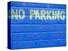 Painted Blue Brick Wall with No Parking Sign-John Nordell-Stretched Canvas