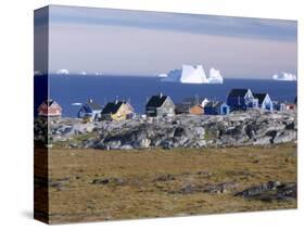 Painted Village Houses in Front of Icebergs in Disko Bay, West Coast, Greenland-Anthony Waltham-Stretched Canvas