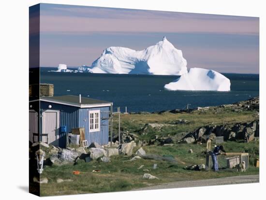 Painted Wooden Fisherman's House in Front of Icebergs in Disko Bay, Disko Island, Greenland-Tony Waltham-Stretched Canvas