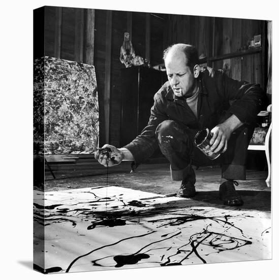 Painter Jackson Pollock Working in His Studio, Cigarette in Mouth, Dropping Paint Onto Canvas-Martha Holmes-Stretched Canvas