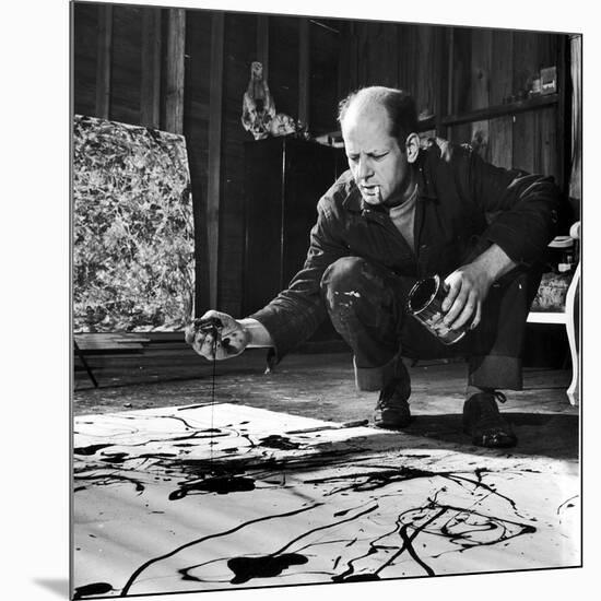 Painter Jackson Pollock Working in His Studio, Cigarette in Mouth, Dropping Paint Onto Canvas-Martha Holmes-Mounted Photographic Print