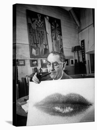 Painter Photographer Man Ray Holding Up "Lips" Print, Winking at Camera and Smoking a Pipe-Loomis Dean-Stretched Canvas