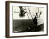 Painters Sitting on Rigging Clean and Paint Side of Ship During Spring Cleaning-J^ Kauffmann-Framed Photographic Print