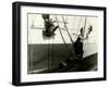 Painters Sitting on Rigging Clean and Paint Side of Ship During Spring Cleaning-J^ Kauffmann-Framed Photographic Print