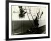 Painters Sitting on Rigging Clean and Paint Side of Ship During Spring Cleaning-J^ Kauffmann-Framed Photographic Print