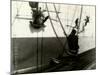 Painters Sitting on Rigging Clean and Paint Side of Ship During Spring Cleaning-J^ Kauffmann-Mounted Photographic Print