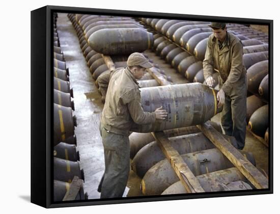 Pair of American Servicemen Moving a Large Bomb at an Ammunition Dump During WWII-null-Framed Stretched Canvas