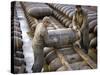 Pair of American Servicemen Moving a Large Bomb at an Ammunition Dump During WWII-null-Stretched Canvas