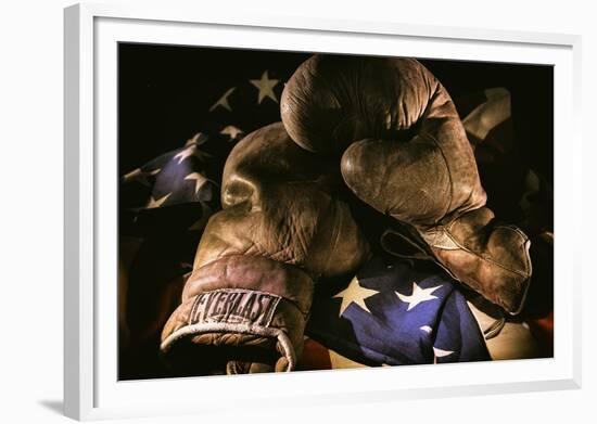 Pair of vintage boxing gloves laying on a flag carefully painted with light-Sheila Haddad-Framed Photographic Print