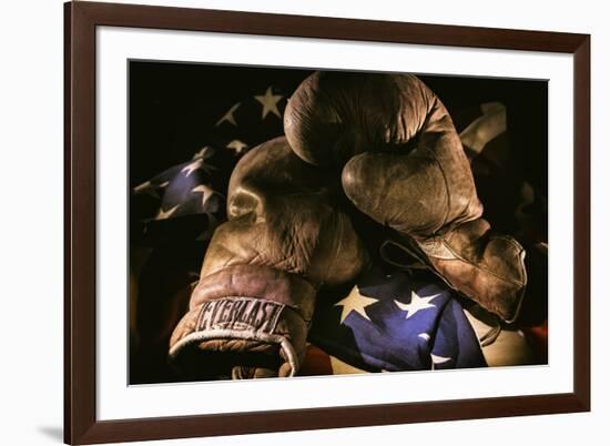 Pair of vintage boxing gloves laying on a flag carefully painted with light-Sheila Haddad-Framed Photographic Print