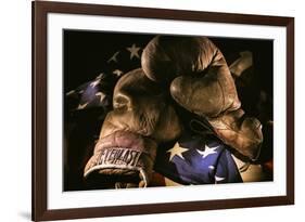 Pair of vintage boxing gloves laying on a flag carefully painted with light-Sheila Haddad-Framed Photographic Print