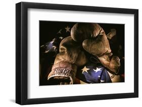 Pair of vintage boxing gloves laying on a flag carefully painted with light-Sheila Haddad-Framed Photographic Print