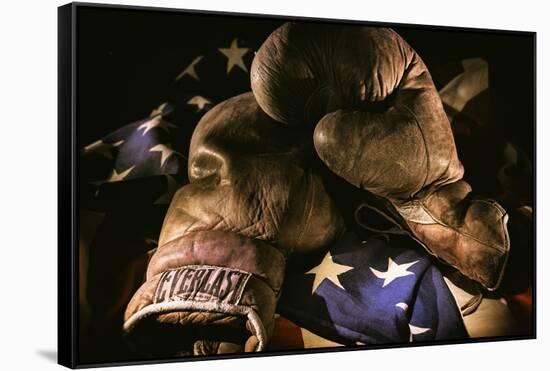 Pair of vintage boxing gloves laying on a flag carefully painted with light-Sheila Haddad-Framed Stretched Canvas