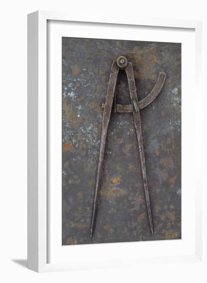 Pair of Vintage Tarnished Measuring Dividers Or Compasses Lying On Rusty Metal Sheet-Den Reader-Framed Photographic Print