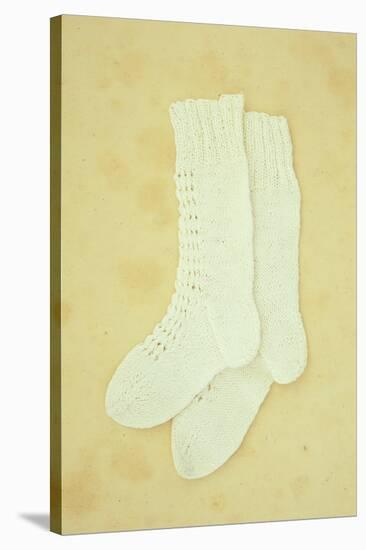 Pair of White Crocheted Childrens Socks Lying on Antique Paper-Den Reader-Stretched Canvas