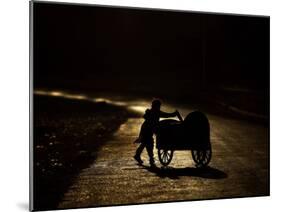 Pakistani Boy Pushes a Cart Along the Main Street in Rawalpindi, Pakistan-null-Mounted Photographic Print