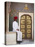 Palace Guard Sitting at Rose Gate in Pitam Niwas Chowk, City Palace, Jaipur, Rajasthan, India, Asia-Ian Trower-Stretched Canvas