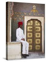 Palace Guard Sitting at Rose Gate in Pitam Niwas Chowk, City Palace, Jaipur, Rajasthan, India, Asia-Ian Trower-Stretched Canvas