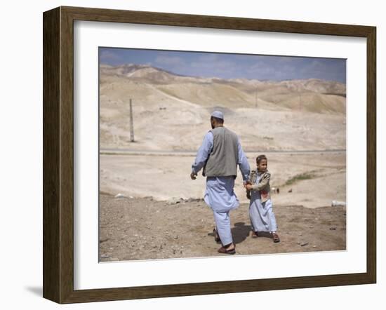 Palestinian Father and Son Walk in Desert During Celebrations Marking the Annual Day of Nebi Musa-null-Framed Photographic Print