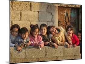 Palestinian Girls Giggle While Photographed Where Shell from an Israeli Gunboat Landed Earlier-null-Mounted Photographic Print