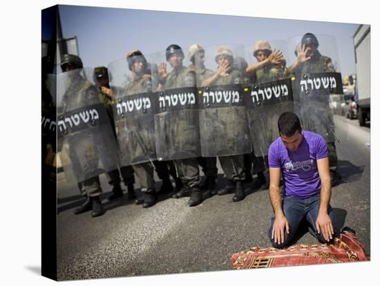 Palestinian Worshipper Prays Outside Jerusalem's Old City While Israeli Forces Stand Guard-null-Stretched Canvas