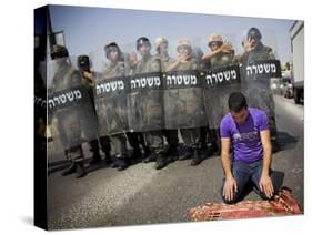 Palestinian Worshipper Prays Outside Jerusalem's Old City While Israeli Forces Stand Guard-null-Stretched Canvas