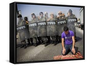 Palestinian Worshipper Prays Outside Jerusalem's Old City While Israeli Forces Stand Guard-null-Framed Stretched Canvas