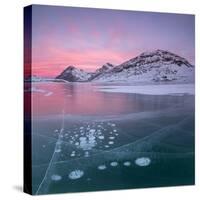 Panorama of ice bubbles and frozen surface of Lago Bianco at dawn, Bernina Pass, canton of Graubund-Roberto Moiola-Stretched Canvas