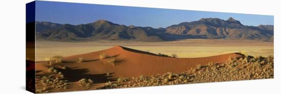 Panoramic View Over Orange Sand Dunes Towards Mountains, Namib Rand Private Game Reserve, Namibia-Lee Frost-Stretched Canvas