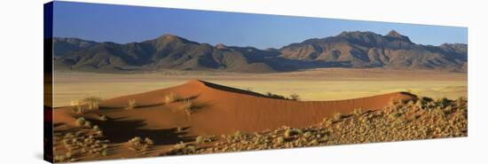 Panoramic View Over Orange Sand Dunes Towards Mountains, Namib Rand Private Game Reserve, Namibia-Lee Frost-Stretched Canvas