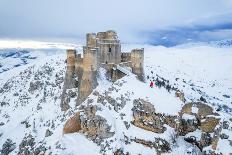 Man admiring the snowy medieval castle of Rocca Calascio after heavy snowfall, Rocca Calascio-Paolo Graziosi-Photographic Print
