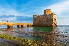Man on the bridge walks to the fortified castle of Torre Astura in the water of Tyrrhenian Sea-Paolo Graziosi-Photographic Print