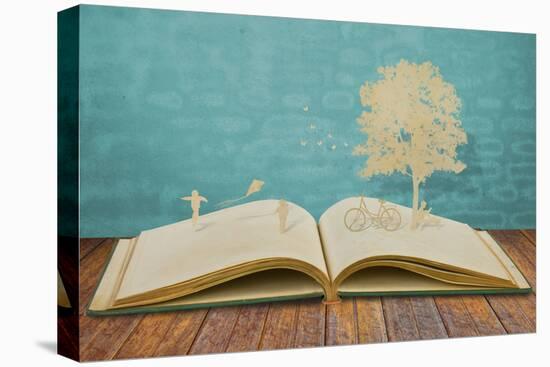 Paper Cut of Children Play on Old Book-jannoon028-Stretched Canvas