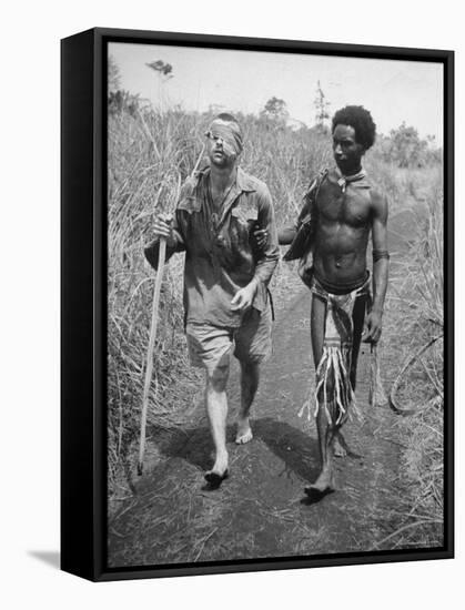 Papuan Native Helping a Wounded Australian Infantryman Along Road Away from the Buna Battlefront-George Silk-Framed Stretched Canvas