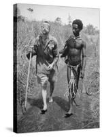 Papuan Native Helping a Wounded Australian Infantryman Along Road Away from the Buna Battlefront-George Silk-Stretched Canvas