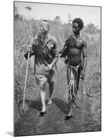 Papuan Native Helping a Wounded Australian Infantryman Along Road Away from the Buna Battlefront-George Silk-Mounted Photographic Print