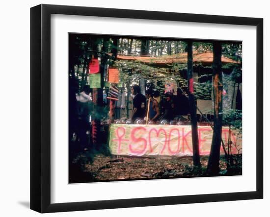 Paraphernalia Stand in Woods Featuring Pillows, Posters, and Incense, Woodstock Music and Art Fair-John Dominis-Framed Photographic Print